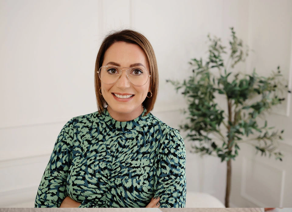 Caroline Burnell, Counsellor, stood with folded arms and smiling into the camera.